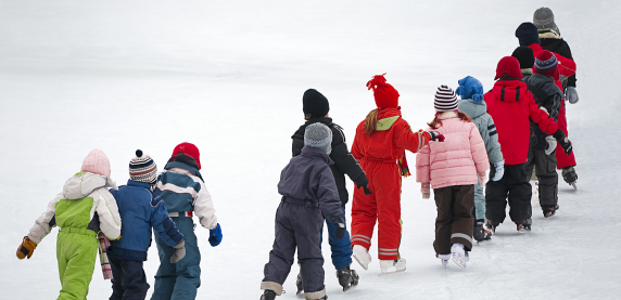 Grupa dzieci idąca w śnieżnej scenerii