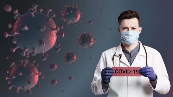 Lekarz z tabliczką "Covid_19"