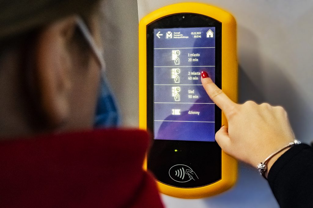 Osoba używająca automatu biletowego